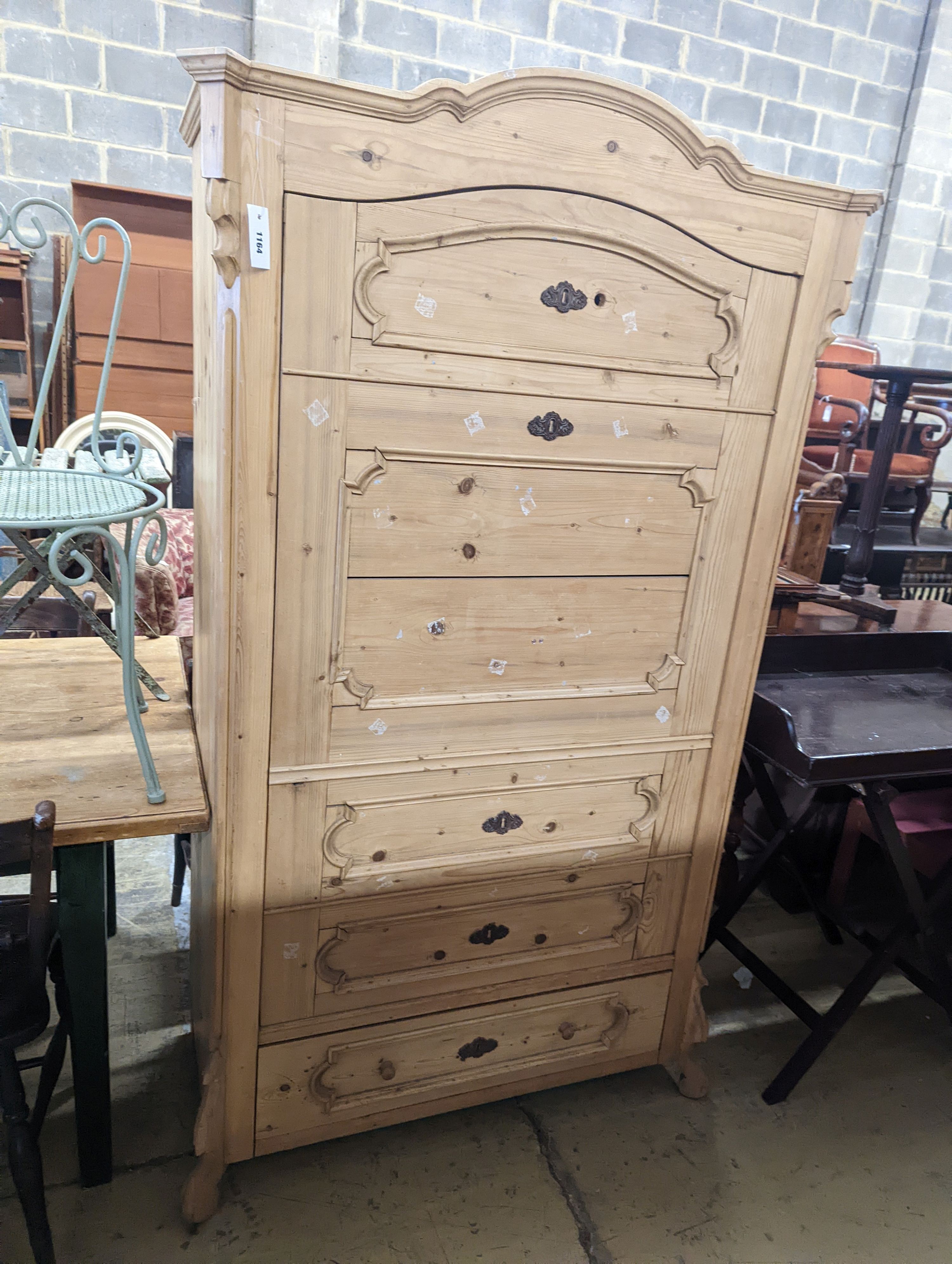 A 19th century Continental pale pine hanging cupboard with dummy drawer front, width 104cm, depth 50cm, height 183cm